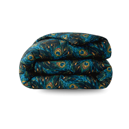 Het Zelesta Wonderbed - Pauwenveren is een gevouwen dekbed met een donkerblauw en groen pauwenverenpatroon op wit. Het is een anti-allergisch, wasbaar dekbed voor gemakkelijk onderhoud.