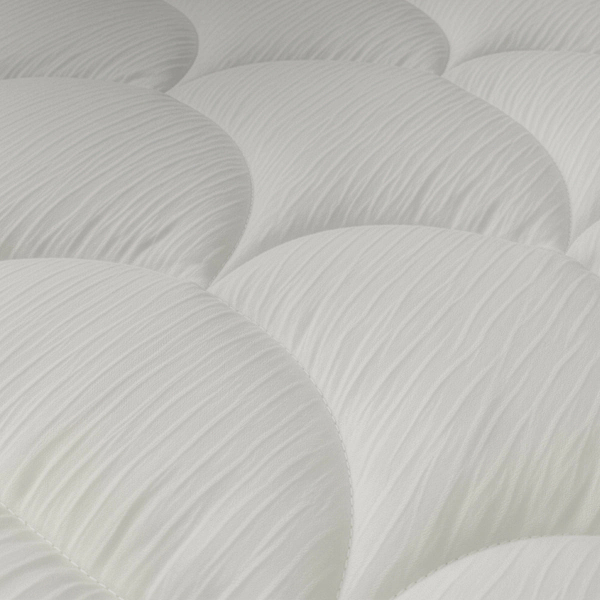 Close-up van het Zelesta Flanel Velvet Bed Chique in beige, met een wit gewatteerd oppervlak met ronde, gewatteerde delen en structuurstof voor een luxueus zachte, comfortabele slaap.