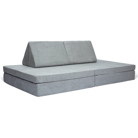 De BAAAP - De geliefde speelbank - Grace of Grey is een grijze modulaire vloerbank met twee driehoekige rugleuningen en een opvouwbaar ontwerp, ideaal voor kinderen om te relaxen of om ruimtelijk inzicht te ontwikkelen tijdens het spelen.